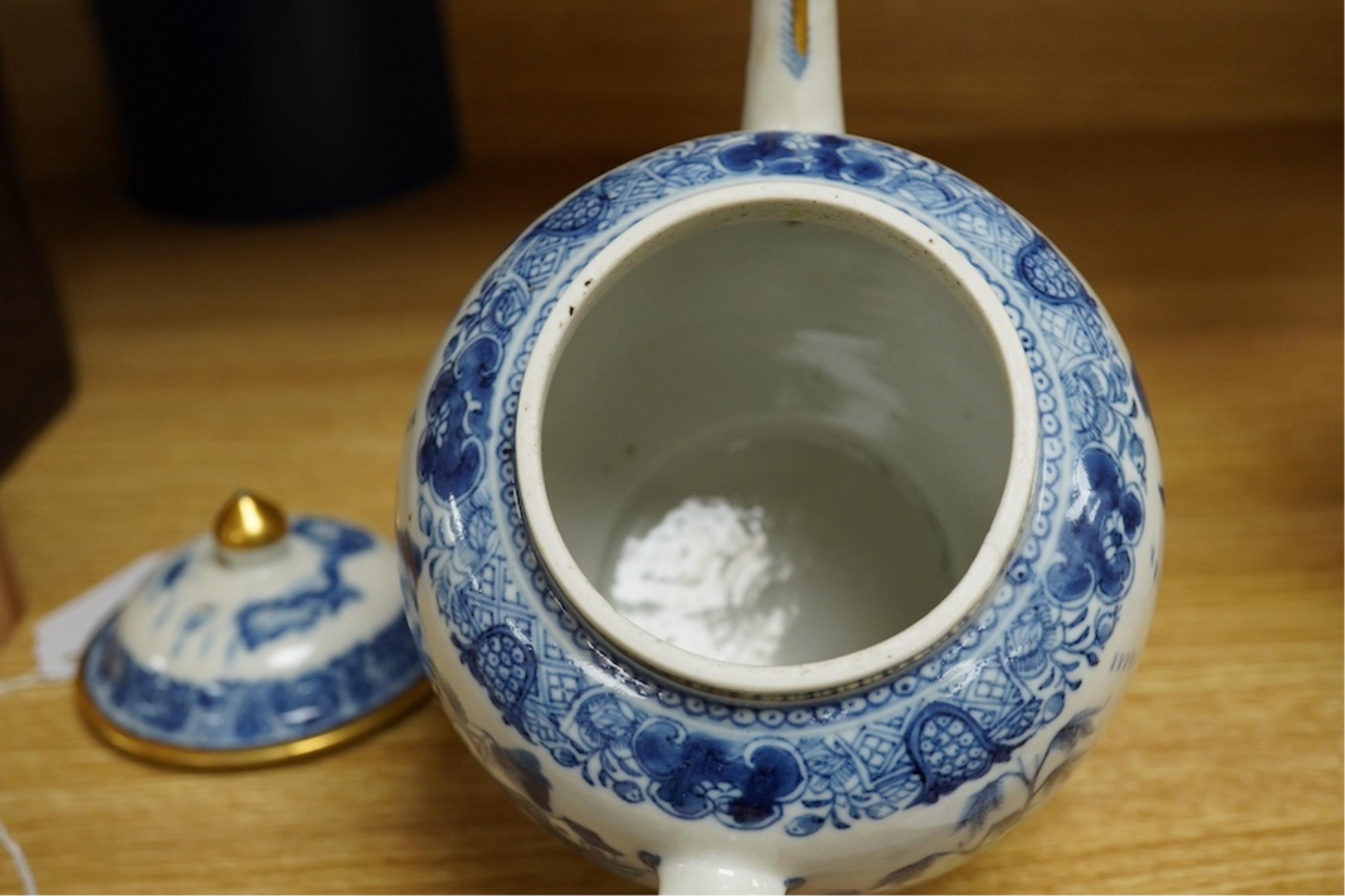 A Chinese export blue and white teapot, c.1790, painted with pagodas, 24cm wide. Condition - some chipping and firing cracks